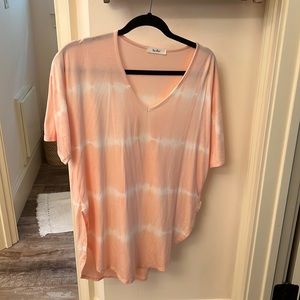 Women’s peach and white lightweight, short sleeve blouse.